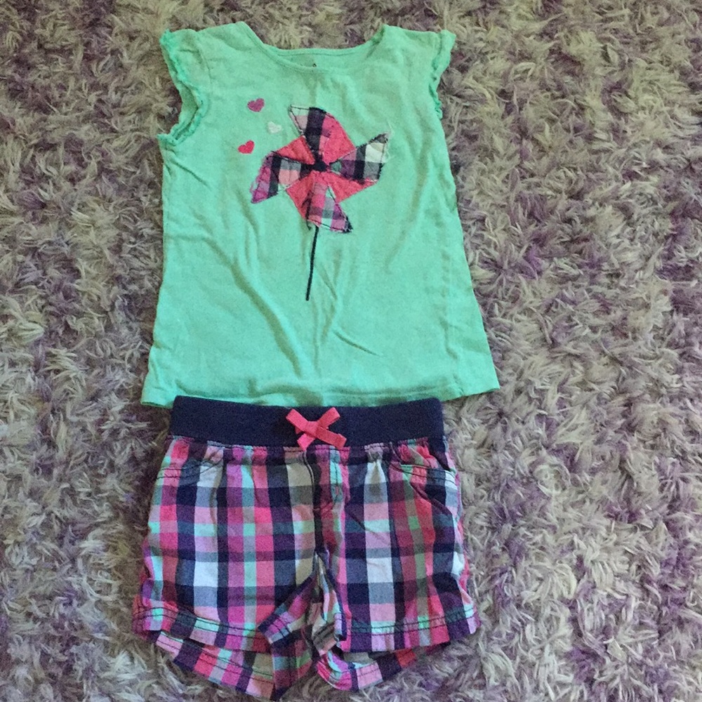 Teal shirt, and Checkered pants.